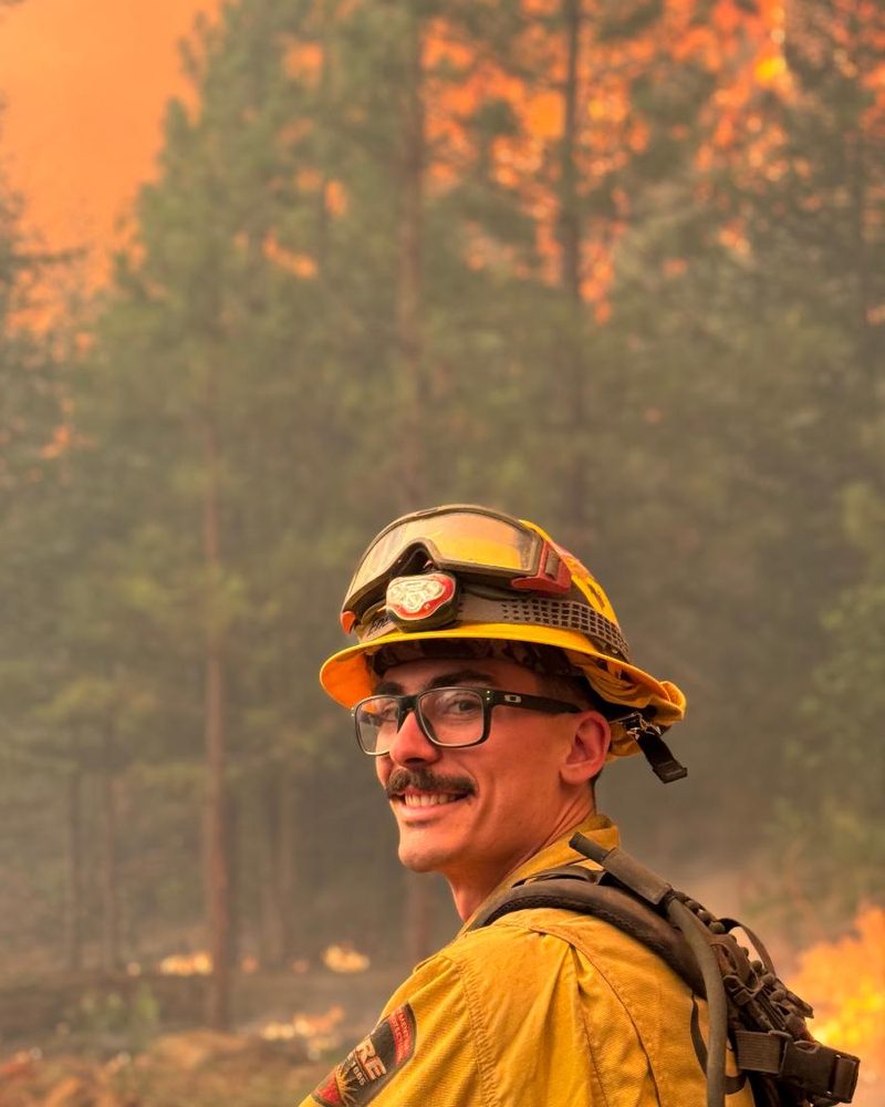 Joshua Smario in wildland fire gear on an active fire line